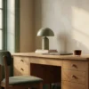 A quiet home office desk at dawn, the AJNEXA Pricing Calculator setting