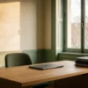 A consultant's desk in late afternoon, document folders squared on the corner